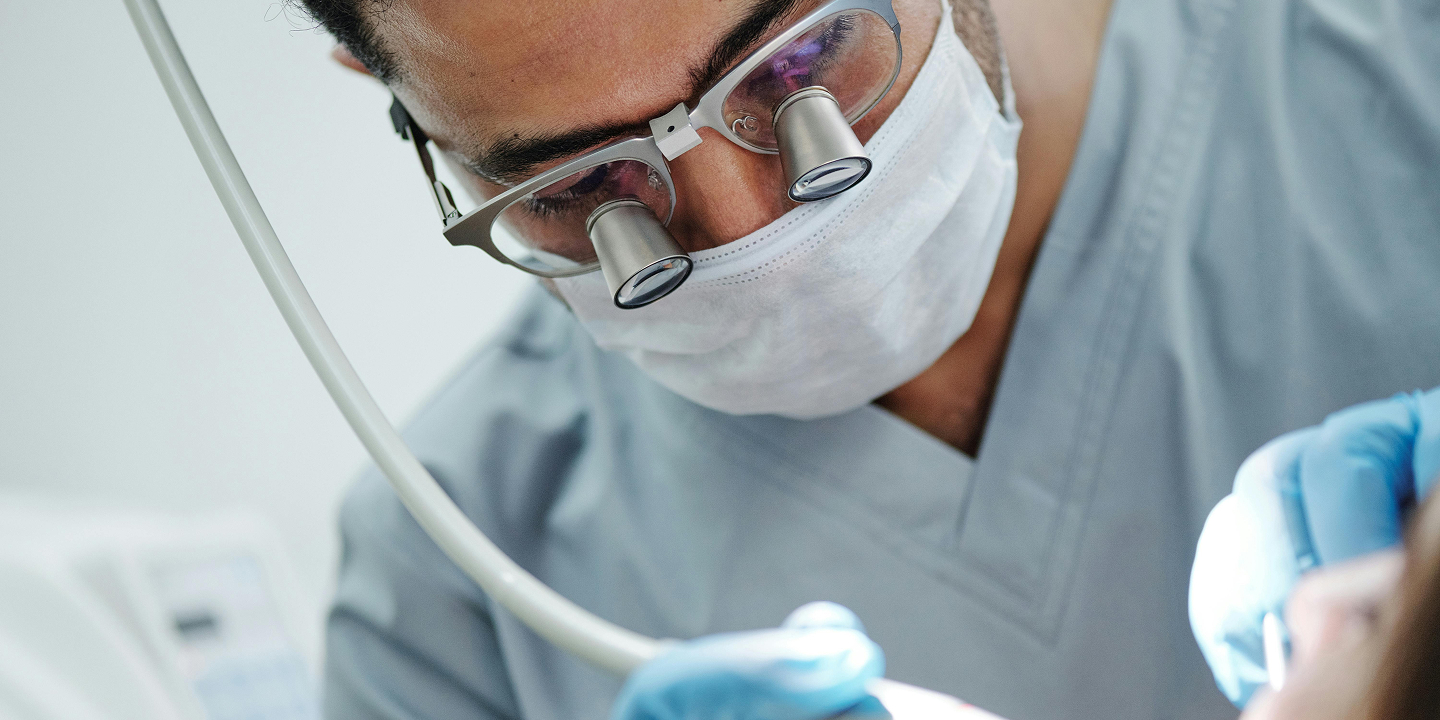 Dentist demonstrating with a dental model to a patient